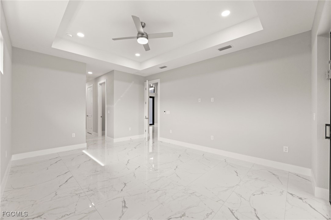 2829 Southwest 25th Place Cape Coral, FL 33914 - Photo 17 of 45 an empty room with a ceiling fan and carpet