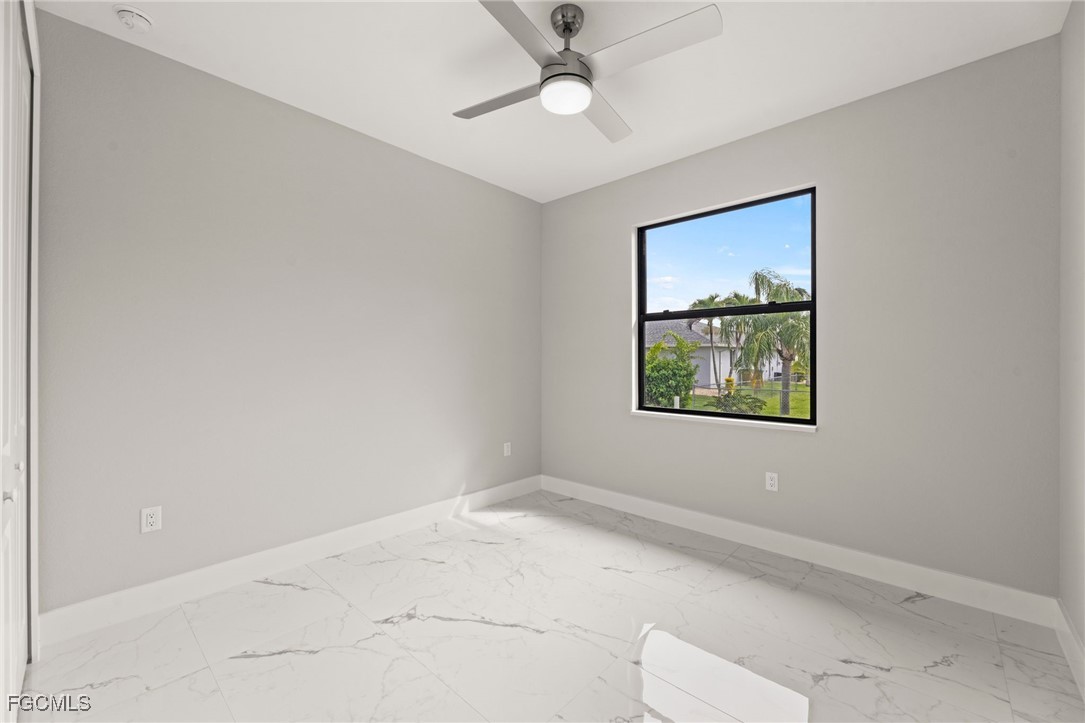 2829 Southwest 25th Place Cape Coral, FL 33914 - Photo 25 of 45 an empty room with windows and ceiling fan