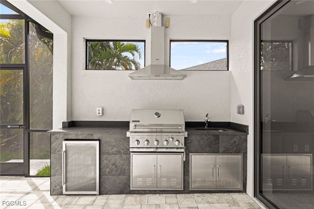 2829 Southwest 25th Place Cape Coral, FL 33914 - Photo 30 of 45 a kitchen with stainless steel appliances granite countertop a refrigerator and a stove