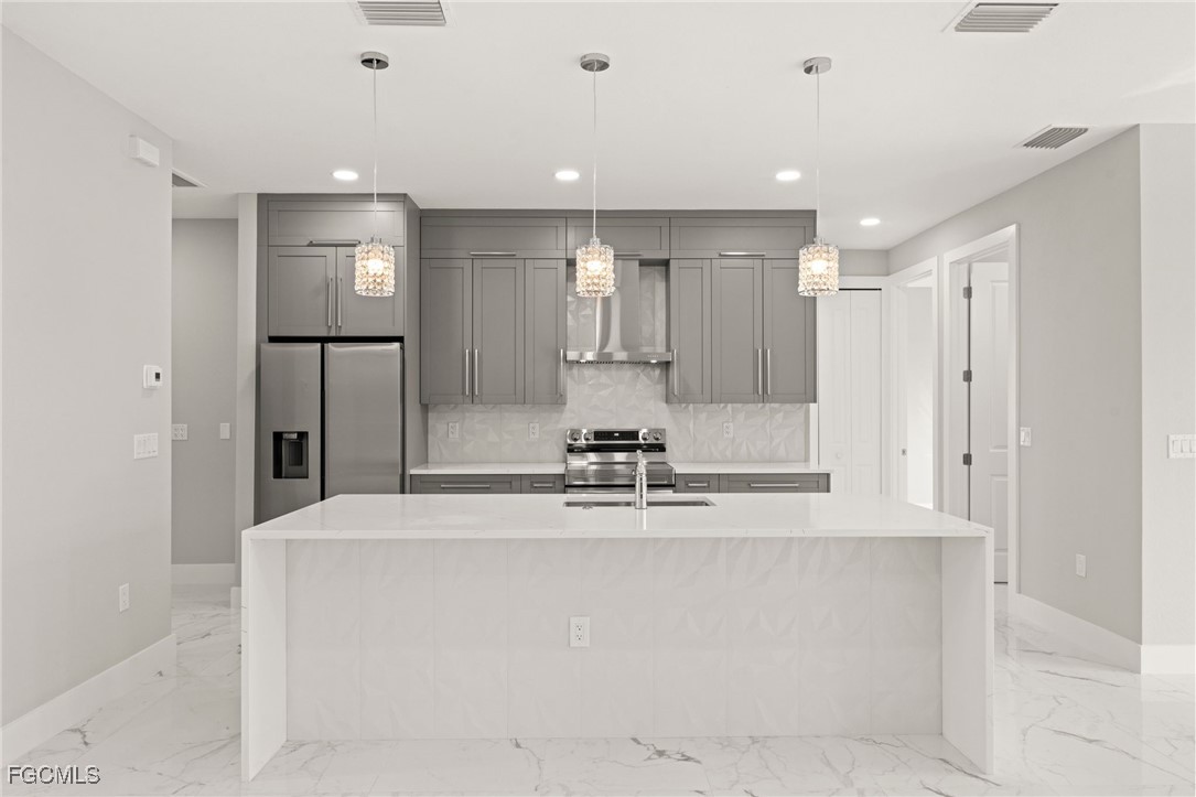 2829 Southwest 25th Place Cape Coral, FL 33914 - Photo 9 of 45 a view of kitchen with center island and stainless steel appliances
