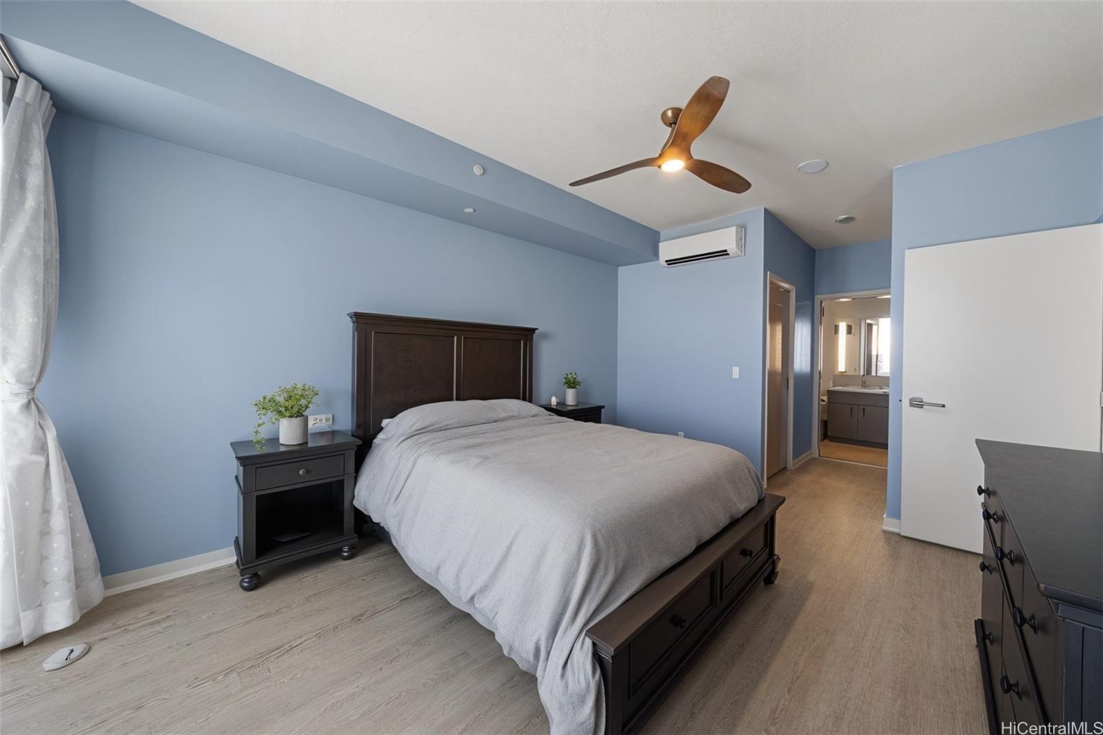 555 South Street, Unit 4202 Honolulu, HI 96813 - Photo 4 of 22 a bedroom with a bed and wooden floor