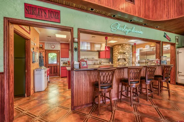 a kitchen with stainless steel appliances granite countertop a sink and a stove