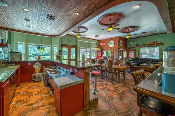 a living room with furniture a fireplace and a chandelier