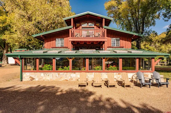 a view of a house with backyard porch and sitting area