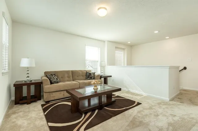 a living room with furniture and a lamp