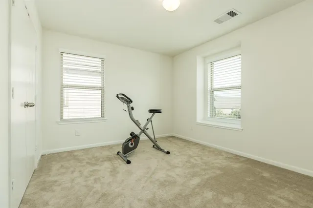 a view of a room with gym equipment and a window