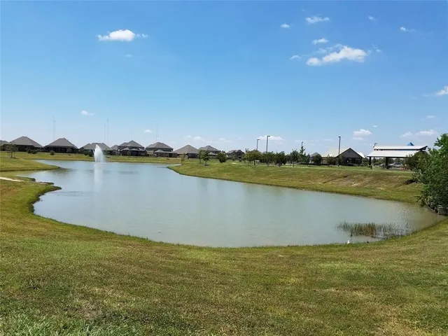 a view of a lake with houses in the background