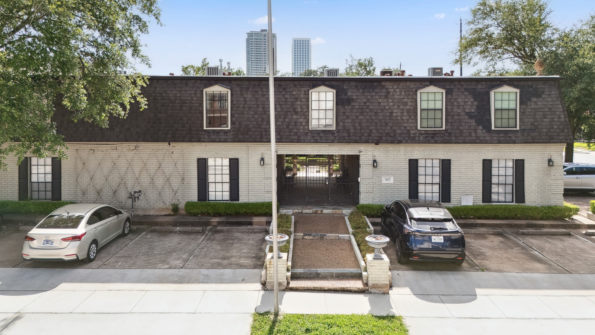 3402 Garrott Street, Unit 15 Houston, TX 77006 - Photo 11 of 17 a front view of a house with garden