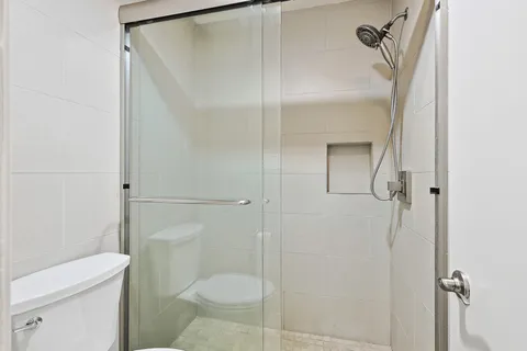 a bathroom with a shower and toilet