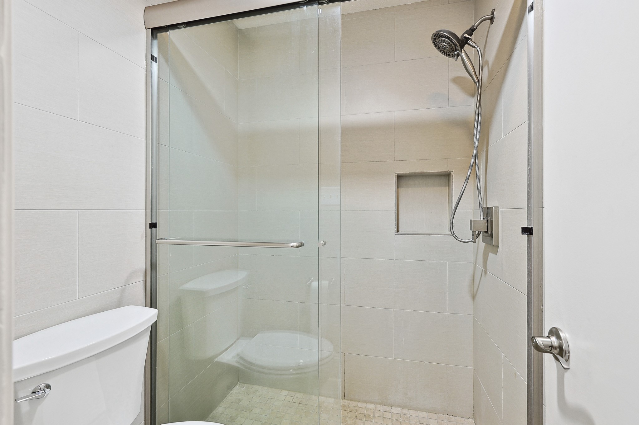 3402 Garrott Street, Unit 15 Houston, TX 77006 - Photo 7 of 17 a bathroom with a shower and toilet