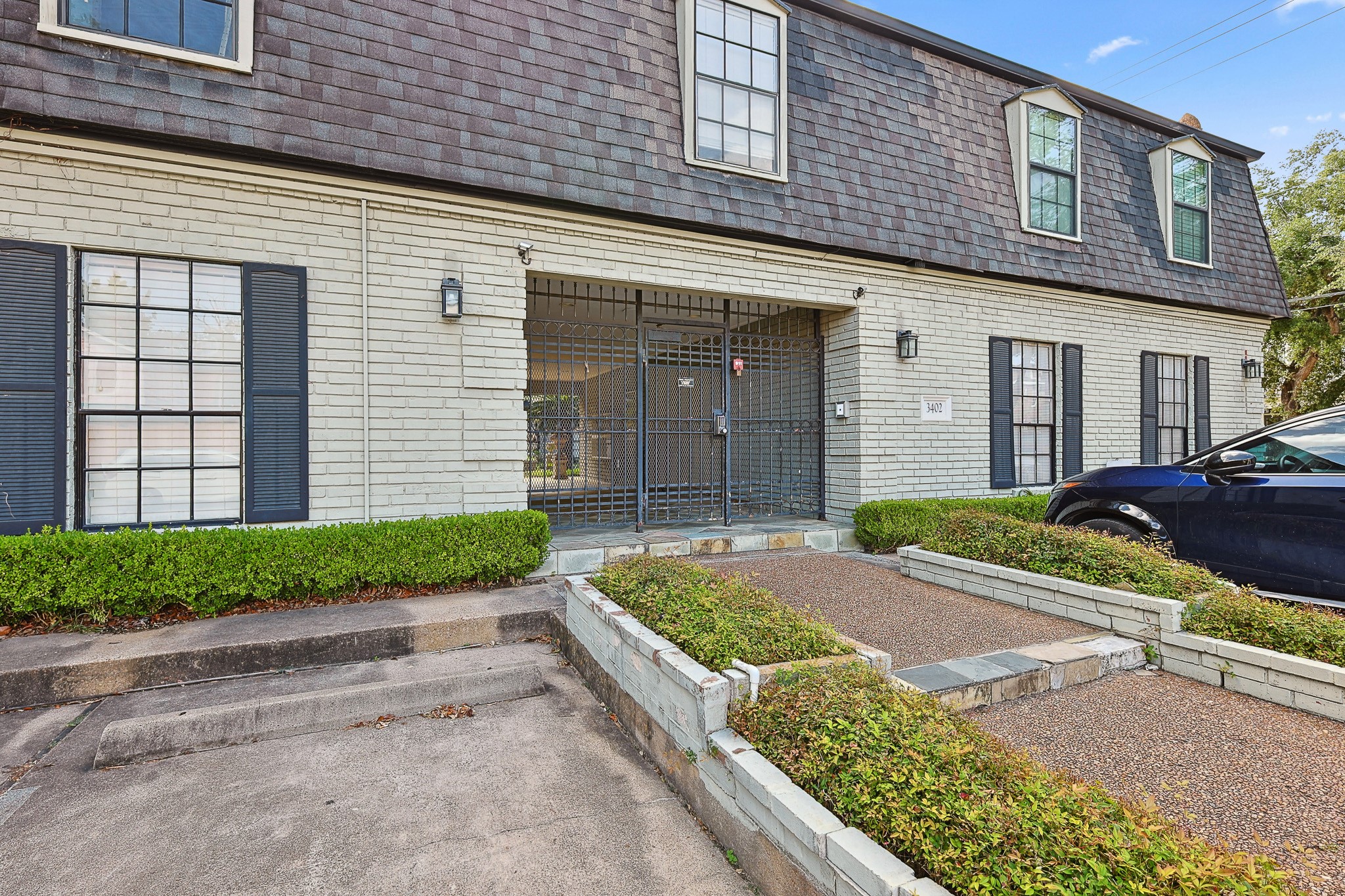3402 Garrott Street, Unit 15 Houston, TX 77006 - Photo 9 of 17 a front view of a house with a yard and garage