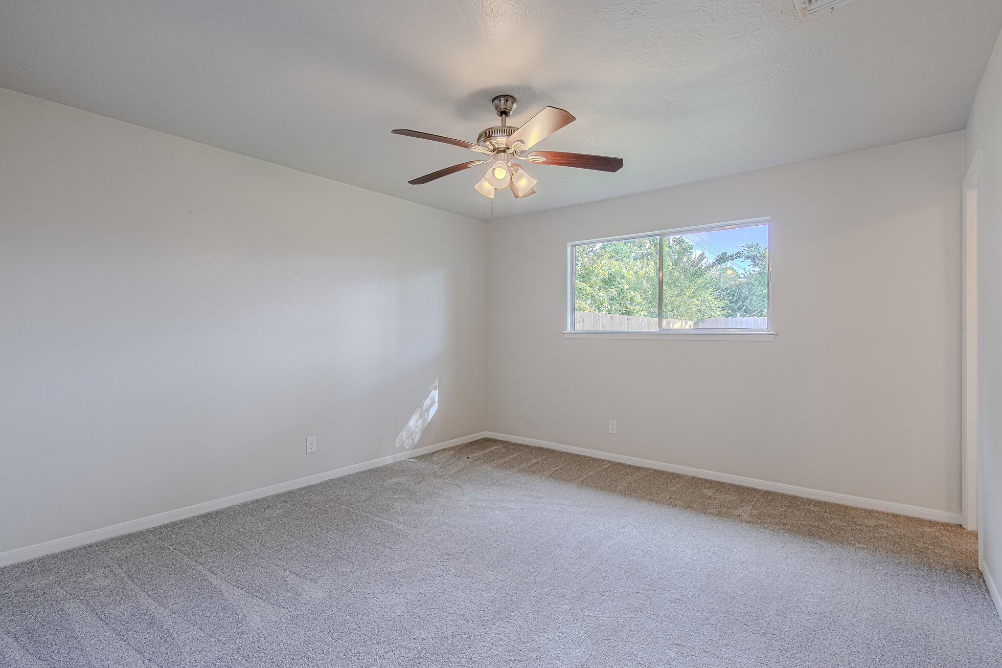 24306 Spring Mill Lane Spring, TX 77373 - Photo 14 of 24 an empty room with windows and fan