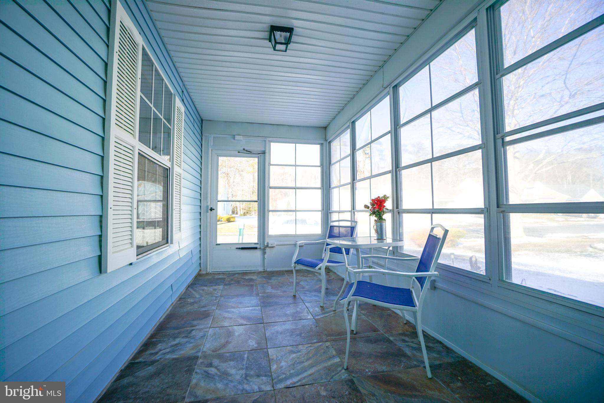 216 Danbury Drive Little Egg Harbor, NJ 08087 - Photo 4 of 19 a dining room with furniture large windows and a chandelier