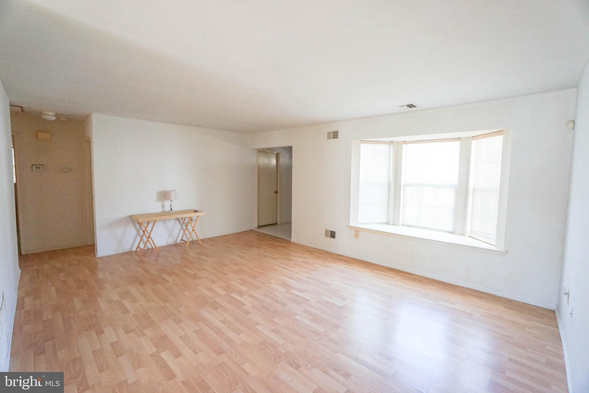 216 Danbury Drive Little Egg Harbor, NJ 08087 - Photo 6 of 19 a view of an empty room with a window and wooden floor