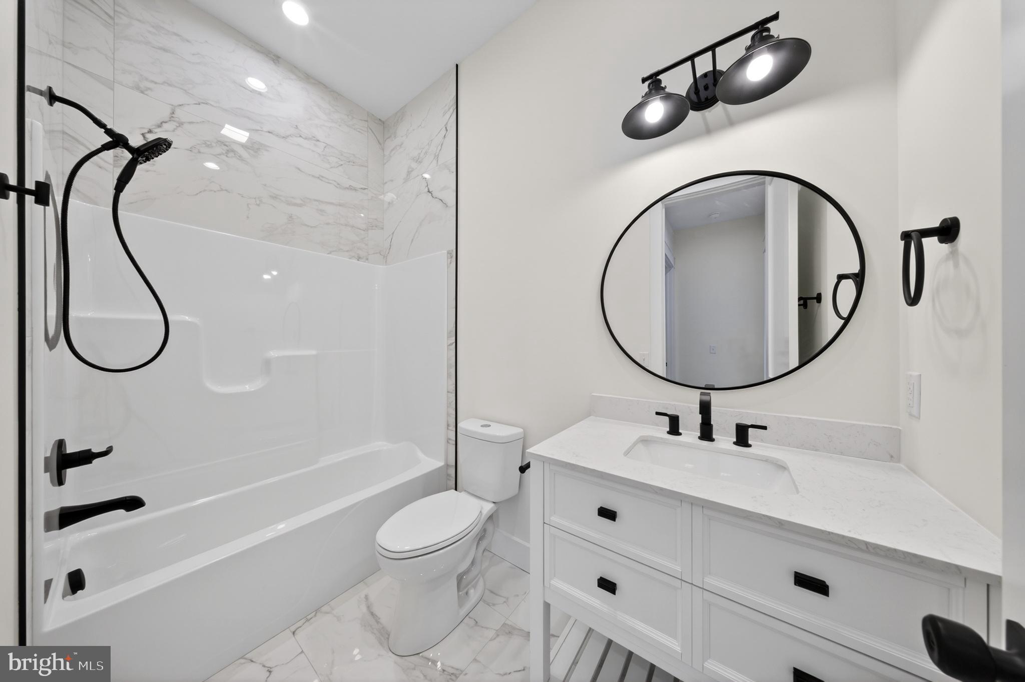 14133 Pepperbox Road Delmar, DE 19940 - Photo 46 of 59 a bathroom with a granite countertop sink a toilet and a mirror
