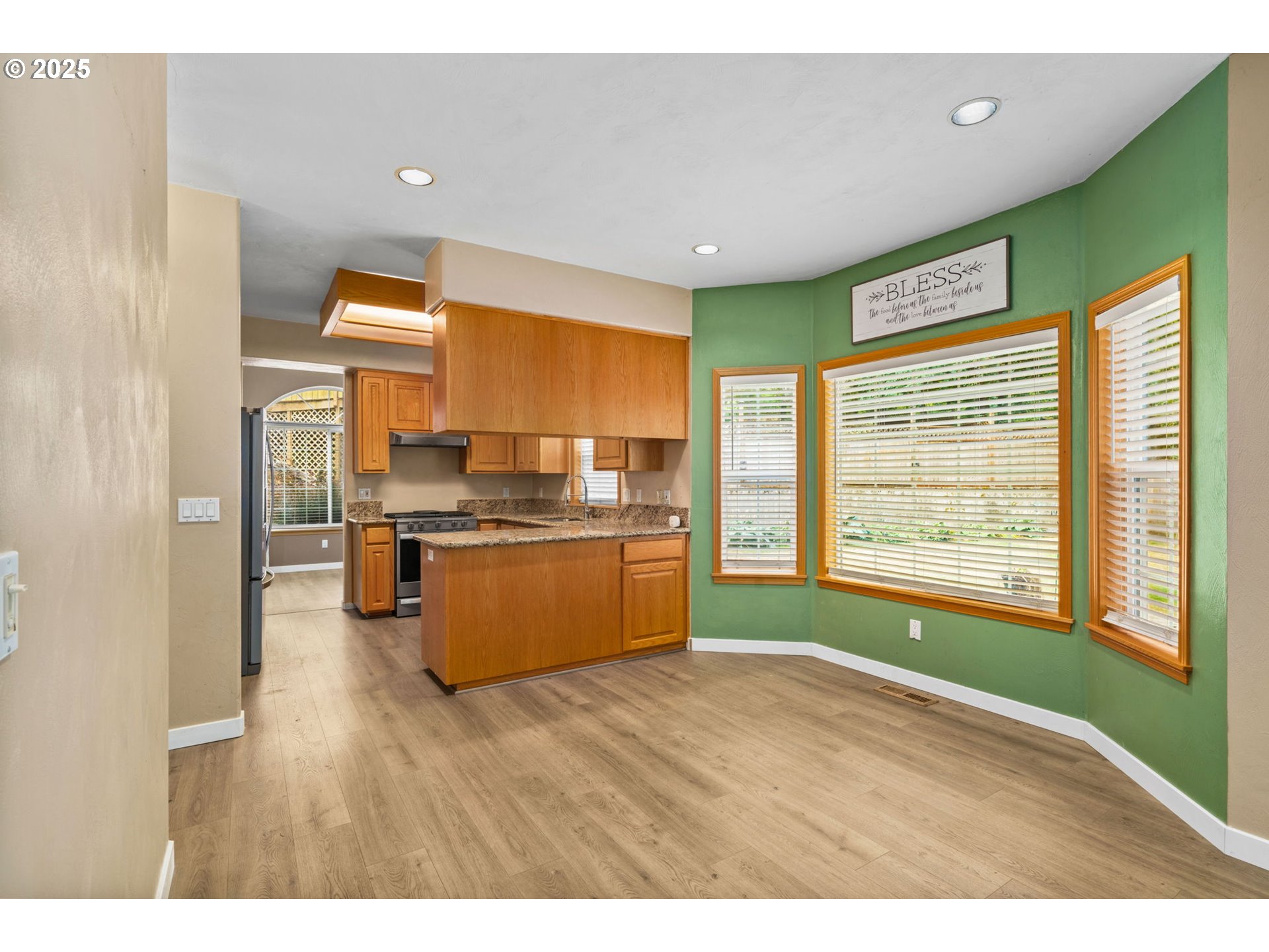 1162 South 69th Street Springfield, OR 97478 - Photo 12 of 37 a kitchen with stainless steel appliances kitchen island wooden cabinets and a large window