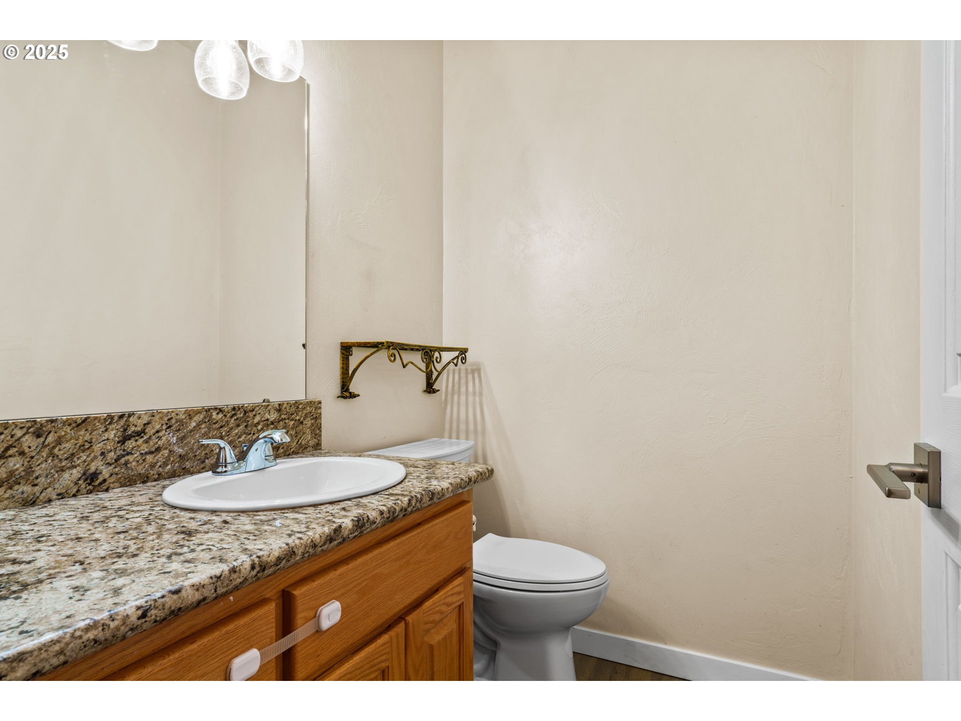 1162 South 69th Street Springfield, OR 97478 - Photo 8 of 37 a bathroom with a granite countertop sink a toilet and a mirror