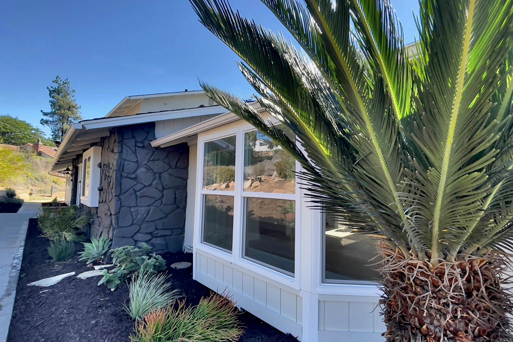 2159 Shire Drive El Cajon, CA 92019 - Photo 2 of 18 a view of a house with a large window and potted plants