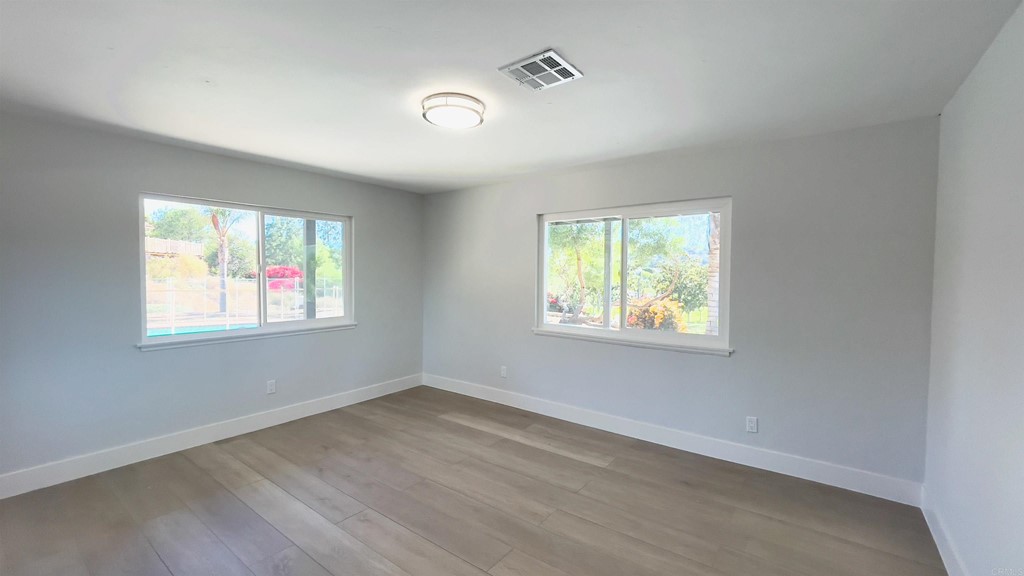 2159 Shire Drive El Cajon, CA 92019 - Photo 12 of 18 an empty room with wooden floor and windows