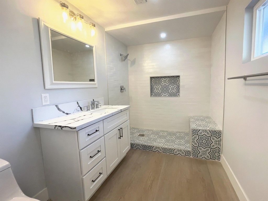 2159 Shire Drive El Cajon, CA 92019 - Photo 14 of 18 a bathroom with a granite countertop sink mirror and vanity