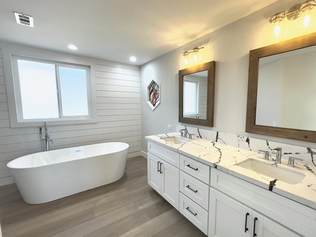 2159 Shire Drive El Cajon, CA 92019 - Photo 15 of 18 a spacious bathroom with a double vanity sink mirror and bathtub