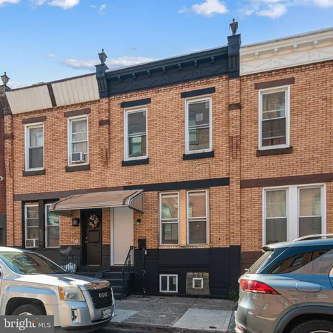 a front view of a house with parking space