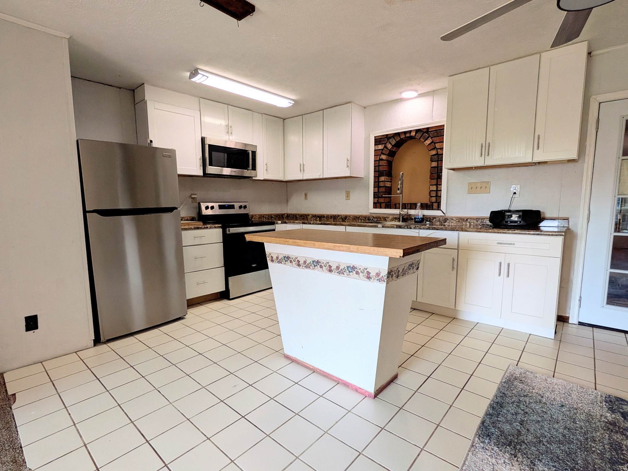 3416 Erin Road McEwen, TN 37101 - Photo 7 of 43 a kitchen with stainless steel appliances granite countertop a stove a sink a refrigerator a microwave and cabinets
