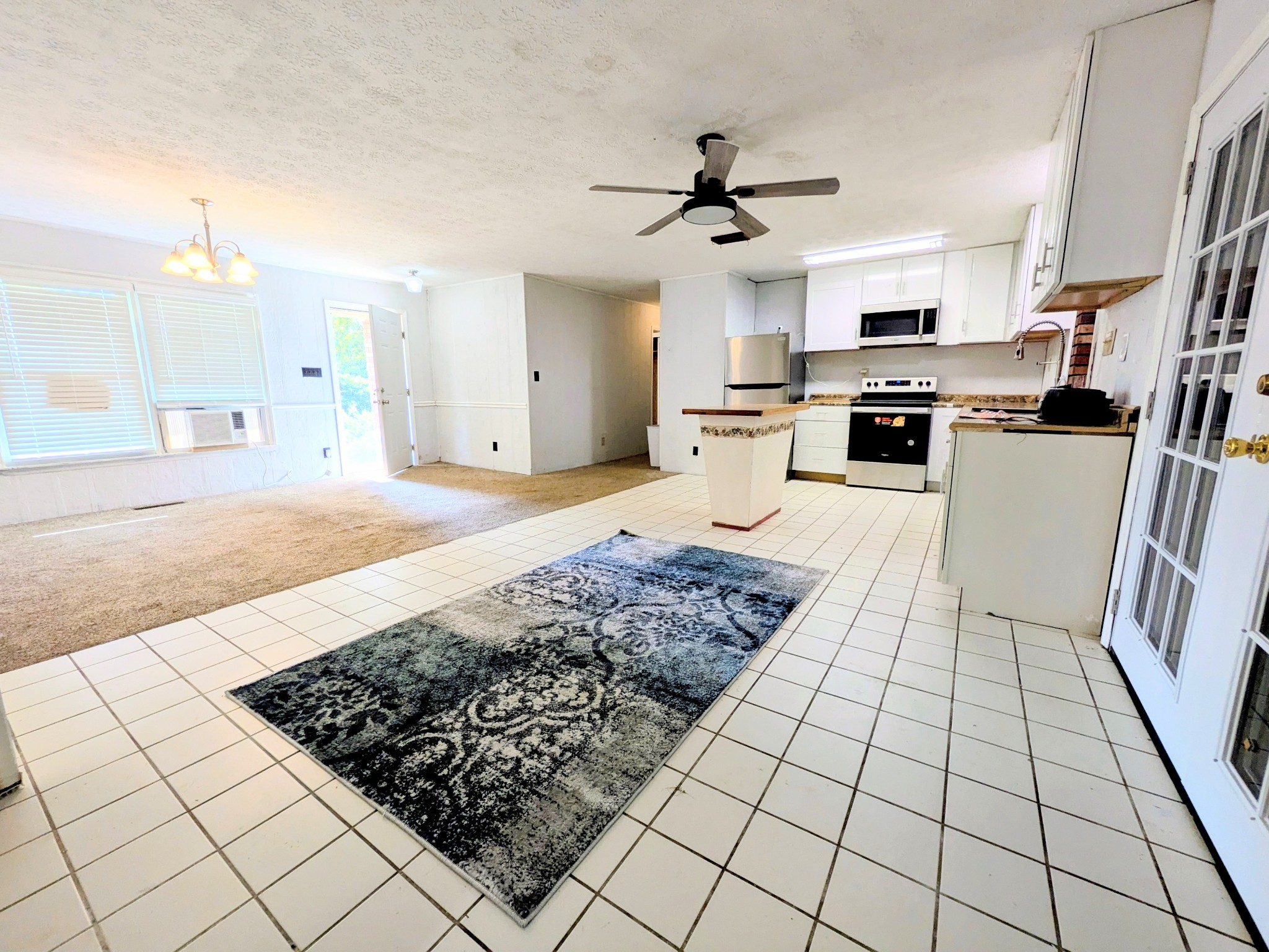 3416 Erin Road McEwen, TN 37101 - Photo 8 of 43 a living room with stainless steel appliances kitchen island granite countertop a rug stove and white cabinets