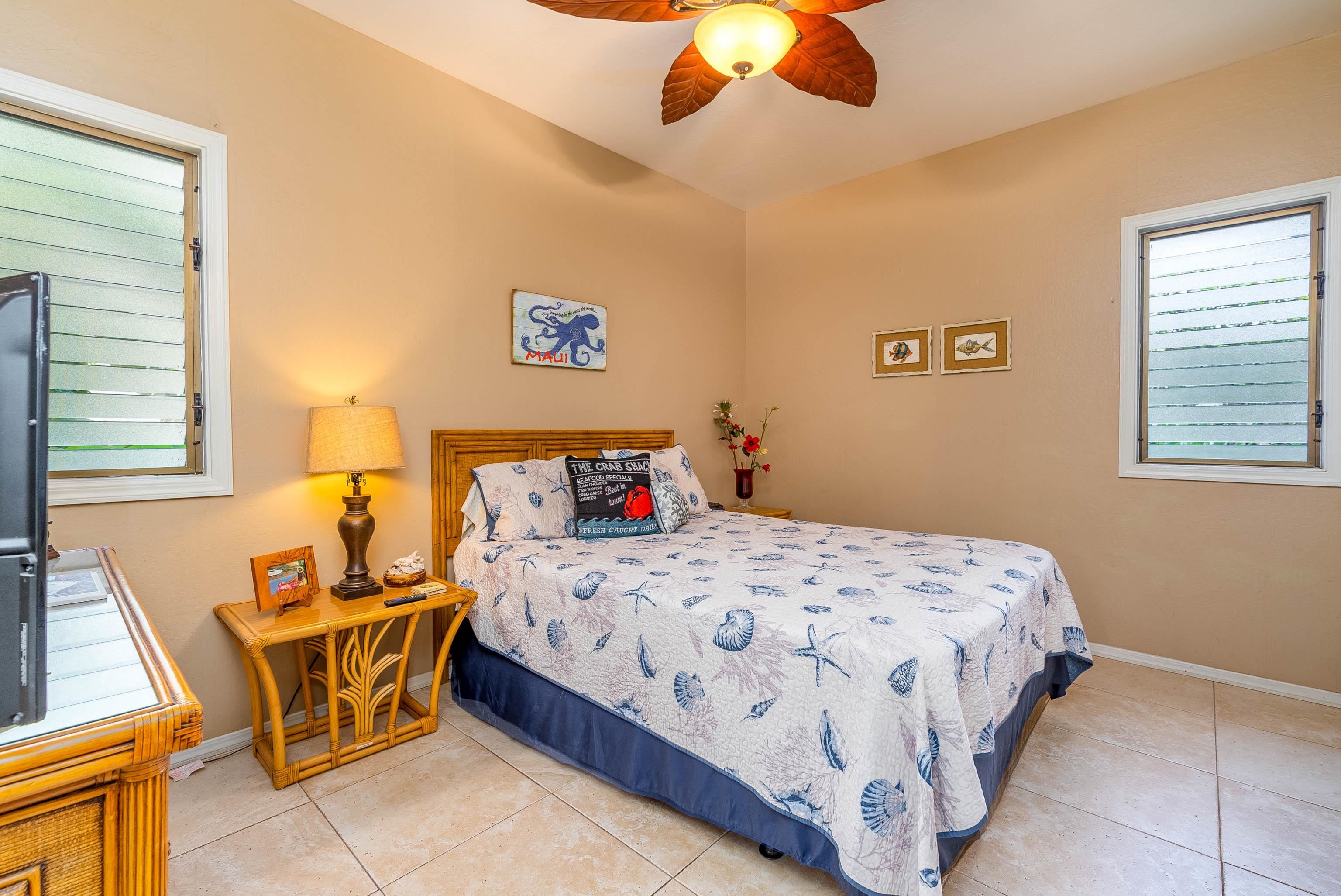 4440 Lower Honoapiilani Road, Unit 154 Lahaina, HI 96761 - Photo 21 of 32 a bedroom with a bed and wooden floor