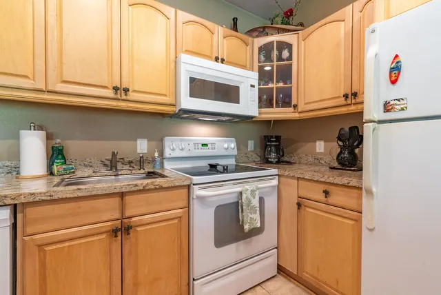 a kitchen with stainless steel appliances granite countertop a sink a stove and cabinets
