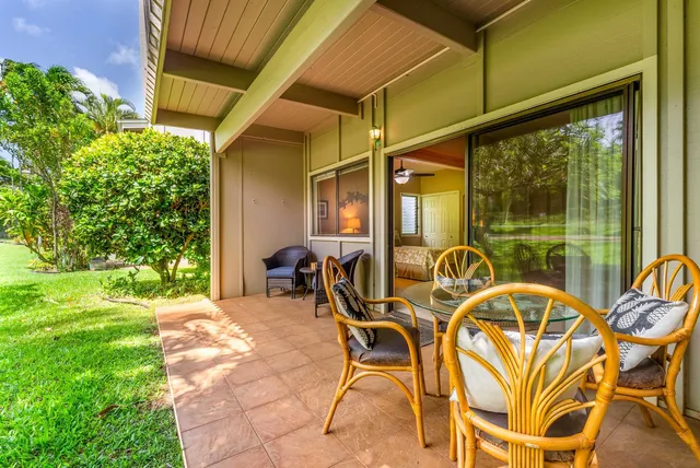 a view of a patio with table and chairs and potted plants