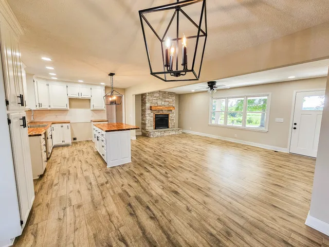 a view of a kitchen with furniture and wooden floor