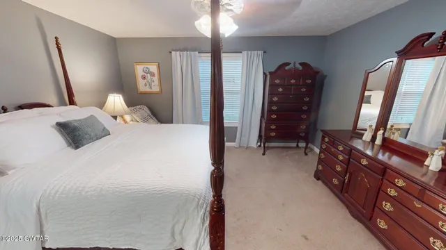 a bedroom with a bed and a mirror on dresser