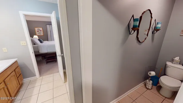 a bathroom with a toilet and a mirror