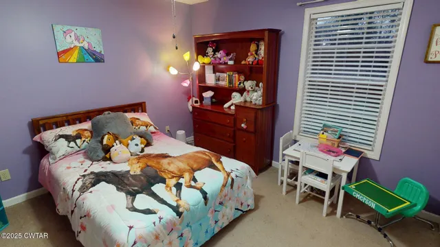 a bedroom with a bed and a workspace