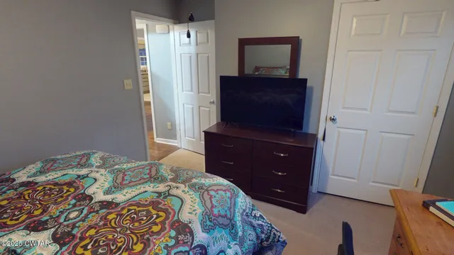 a bedroom with a bed and a dresser
