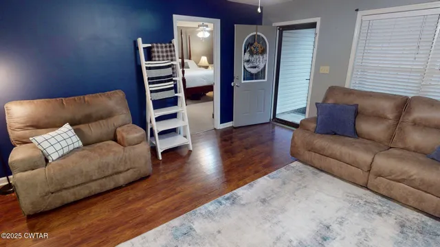 a living room with furniture and wooden floor