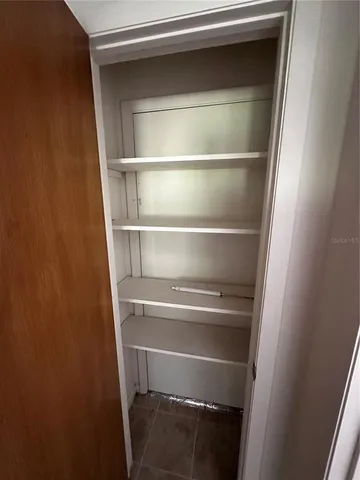 a view of walk in closet with empty racks
