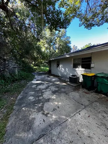 a front view of a house with cars parked