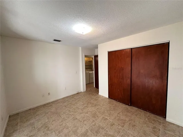 an empty room with closet area