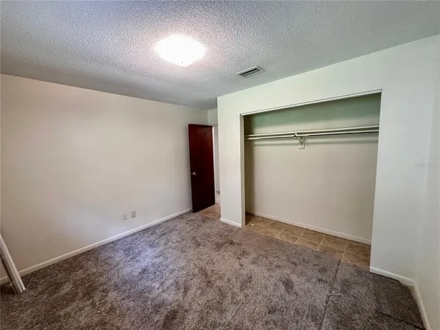 an empty room with closet area