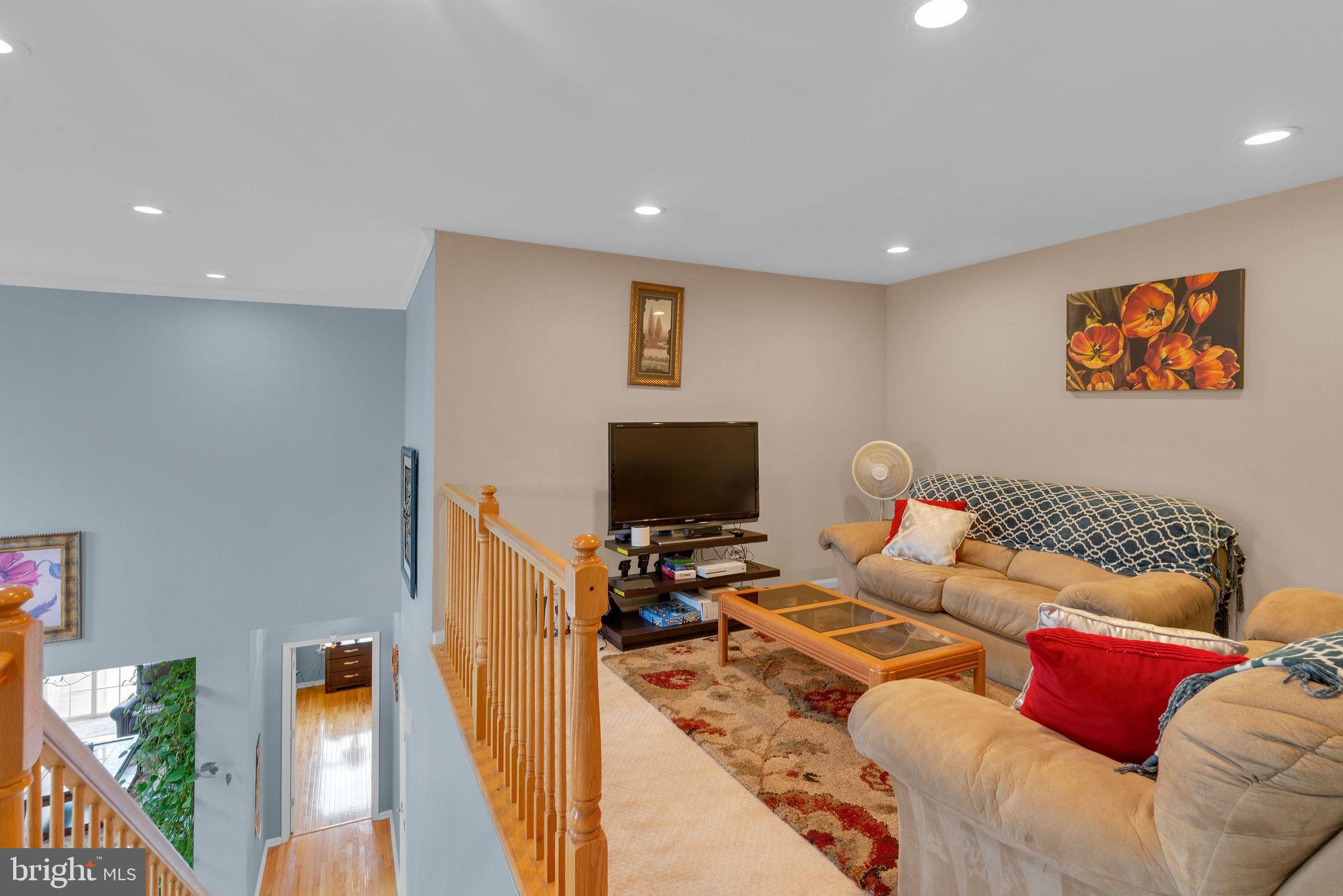 16 Cardiff Court Princeton Junction, NJ 08550 - Photo 20 of 60 a living room with furniture and a flat screen tv