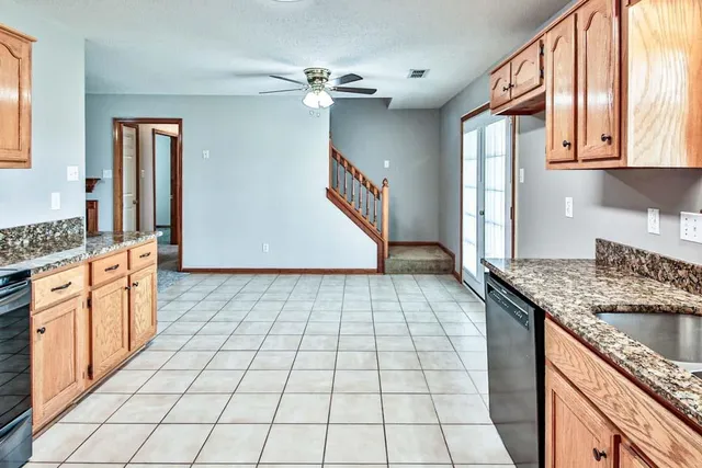 a kitchen with stainless steel appliances granite countertop a sink stove and cabinets