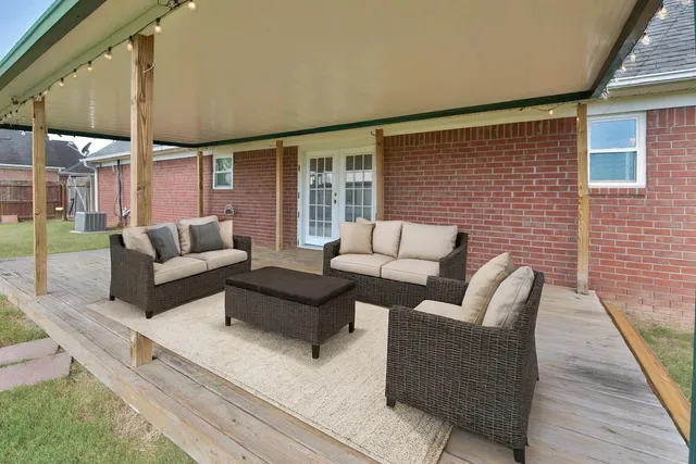 a balcony with furniture and a fireplace