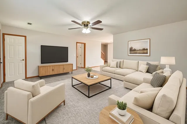 a living room with furniture and a flat screen tv
