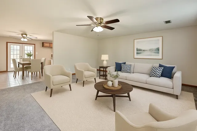 a living room with furniture a rug and a window