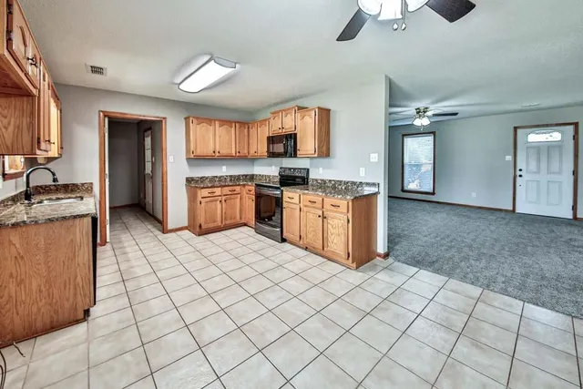 a kitchen with stainless steel appliances granite countertop a sink and a stove top oven