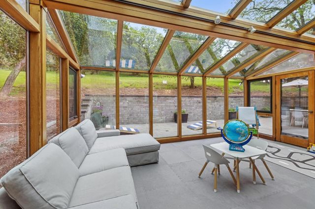 a living room with furniture and a garden