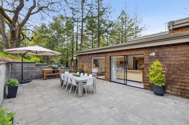 a view of a house with backyard sitting area and garden