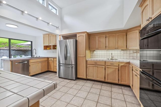 a kitchen with a sink a stove and refrigerator